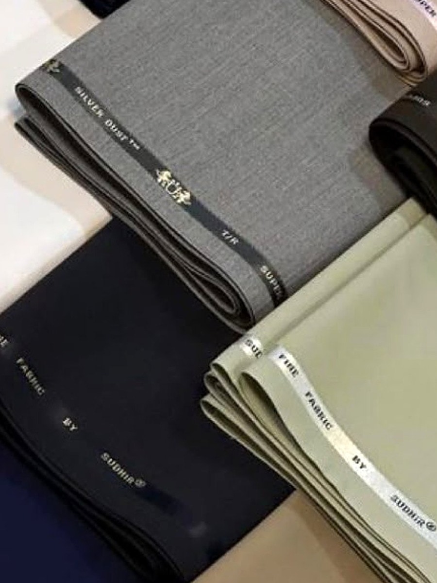 Folded suiting lengths stacked by weight and colour